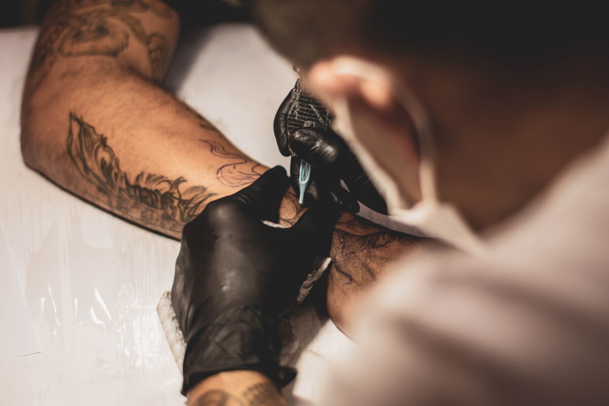 A tattoo artist in Bali doing a sleeve tattoo.