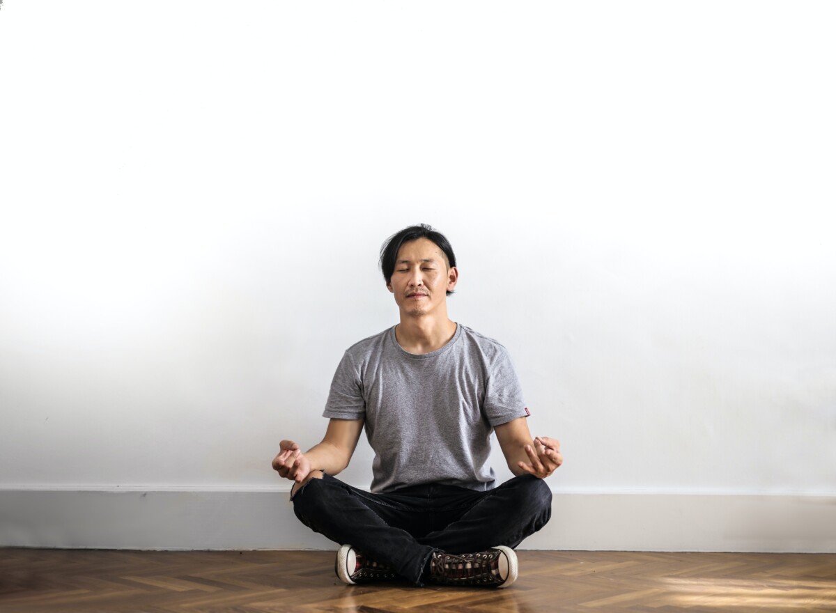 A guy doing meditation for better mental health.